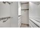 Walk-in closet with white shelving and drawers plus rustic metal racks for hanging clothes at 3080 Yankee Clipper Dr, Las Vegas, NV 89117