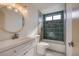 Modern bathroom featuring new tiling, tub, toilet, and a sleek white vanity at 3118 Floral Vista Ave, Henderson, NV 89014