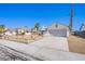 Street view of a single-story home showcasing a two-car garage and desert landscaping at 3118 Floral Vista Ave, Henderson, NV 89014
