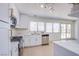 Bright kitchen features stainless steel appliances, white cabinetry, and double windows with natural light at 3118 Floral Vista Ave, Henderson, NV 89014