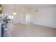Open-concept living room leading to the kitchen area with modern lighting fixture at 3118 Floral Vista Ave, Henderson, NV 89014