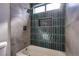Modern bathroom with green and gray tile at 3118 Floral Vista Ave, Henderson, NV 89014