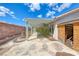 Backyard featuring an extensive patio cover and a brick perimeter wall for privacy and outdoor living at 3413 Freestone Ln, North Las Vegas, NV 89032