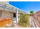 This backyard boasts a covered patio and lush greenery, perfect for outdoor relaxation and entertaining at 3413 Freestone Ln, North Las Vegas, NV 89032