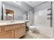 This bathroom boasts a full tub and shower with a large mirror, a vanity with a sink, and tile flooring at 3413 Freestone Ln, North Las Vegas, NV 89032