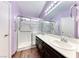 Bright bathroom with double sinks, walk-in shower with glass enclosure and wood-look floors at 3413 Freestone Ln, North Las Vegas, NV 89032