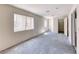 Empty bedroom features plush carpeting, 2 windows, and an attached walk-in closet at 3413 Freestone Ln, North Las Vegas, NV 89032