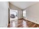 Empty bedroom featuring wood-look floors and view of the living room at 3413 Freestone Ln, North Las Vegas, NV 89032