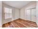 Cozy bedroom with laminate floors, window, and sliding closet door at 3413 Freestone Ln, North Las Vegas, NV 89032