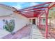 Inviting front entrance featuring a covered walkway and well-maintained landscaping around the front at 3413 Freestone Ln, North Las Vegas, NV 89032