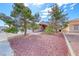 Charming property with rock landscaping and mature trees providing shade and curb appeal at 3413 Freestone Ln, North Las Vegas, NV 89032