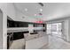 Modern kitchen featuring black cabinets, granite countertops, and stainless steel appliances at 3413 Freestone Ln, North Las Vegas, NV 89032