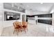 Bright eat-in kitchen with an island, granite countertops, dark cabinets, and view into the living room at 3413 Freestone Ln, North Las Vegas, NV 89032