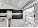 Bright kitchen with dark cabinets, granite countertops, and a sliding door to backyard patio at 3413 Freestone Ln, North Las Vegas, NV 89032