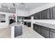 Modern kitchen with dark cabinets, granite countertops, and stainless steel appliances at 3413 Freestone Ln, North Las Vegas, NV 89032