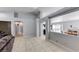Bright and open-concept living room featuring tile floors, neutral paint, and seamless flow to other spaces at 3413 Freestone Ln, North Las Vegas, NV 89032