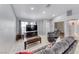 Bright living room featuring tile flooring, neutral paint, and ample natural light, with comfortable seating at 3413 Freestone Ln, North Las Vegas, NV 89032