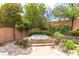 Backyard featuring a hot tub and a garden with roses at 3483 French Daisy St, Las Vegas, NV 89135