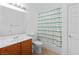 Bathroom featuring a single sink vanity, tiled floor and a shower-tub combo with a patterned curtain at 3483 French Daisy St, Las Vegas, NV 89135