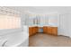 Bathroom featuring a large soaking tub, double vanity, and a decorative glass block window at 3483 French Daisy St, Las Vegas, NV 89135