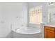 Bathroom featuring a large soaking tub, and a decorative glass block window at 3483 French Daisy St, Las Vegas, NV 89135