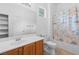 This bathroom features a white vanity, toilet and shower with a ocean-themed shower curtain at 3483 French Daisy St, Las Vegas, NV 89135
