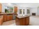Open kitchen features wooden cabinets, granite countertops, and access to both dining and living areas at 3483 French Daisy St, Las Vegas, NV 89135