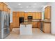 Bright kitchen with wooden cabinets, stainless steel appliances, an island, and a convenient layout at 3483 French Daisy St, Las Vegas, NV 89135