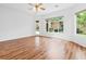 Bright, open room with hardwood floors and large windows offering views of the backyard at 3483 French Daisy St, Las Vegas, NV 89135