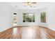 Bright, open room with hardwood floors, large windows and glass door to outdoor space at 3483 French Daisy St, Las Vegas, NV 89135