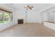 Spacious living room features a fireplace, ceiling fan, and large window offering ample natural light at 3483 French Daisy St, Las Vegas, NV 89135