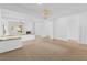 Bright and open living room with a fireplace, chandelier, and tile flooring at 3483 French Daisy St, Las Vegas, NV 89135