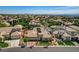 Aerial view of a beautiful home in a well-maintained neighborhood with city views in the background at 3614 Coventry Gardens Dr, Las Vegas, NV 89135
