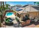 Aerial view of a backyard with a pool, outdoor kitchen and solar panels at 3614 Coventry Gardens Dr, Las Vegas, NV 89135