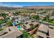Scenic aerial perspective of a community featuring homes with solar panels, pools, and lush landscaping at 3614 Coventry Gardens Dr, Las Vegas, NV 89135