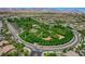 Panoramic aerial shot showcasing a community park with green spaces, trees, and surrounding residential homes at 3614 Coventry Gardens Dr, Las Vegas, NV 89135