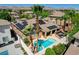Aerial view of a house with a pool and solar panels in a neighborhood with palm trees at 3614 Coventry Gardens Dr, Las Vegas, NV 89135
