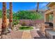 Picturesque backyard featuring an outdoor kitchen, patio space, decorative stone, and a patch of green turf at 3614 Coventry Gardens Dr, Las Vegas, NV 89135