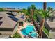 Backyard with a pool, spa, covered patio, and seating area surrounded by lush landscaping and mature trees at 3614 Coventry Gardens Dr, Las Vegas, NV 89135