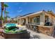 Expansive backyard featuring a built-in barbeque, seating area, outdoor kitchen and a refreshing swimming pool at 3614 Coventry Gardens Dr, Las Vegas, NV 89135