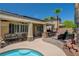 Relaxing backyard oasis with custom outdoor kitchen, seating, a covered patio, and sparkling pool at 3614 Coventry Gardens Dr, Las Vegas, NV 89135