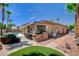 Private backyard area with outdoor built-in kitchen, covered bar, and comfortable seating, surrounded by lush landscaping at 3614 Coventry Gardens Dr, Las Vegas, NV 89135