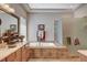 Bathroom featuring double sinks, a soaking tub, and a glass-enclosed shower at 3614 Coventry Gardens Dr, Las Vegas, NV 89135