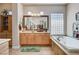 Bright bathroom offers a soaking tub and an abundance of cabinet storage at 3614 Coventry Gardens Dr, Las Vegas, NV 89135