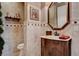 Elegant powder room featuring decorative tile accents and custom wood vanity at 3614 Coventry Gardens Dr, Las Vegas, NV 89135