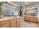 Lavish bathroom featuring dual vanities, framed mirrors, and travertine floors at 3614 Coventry Gardens Dr, Las Vegas, NV 89135