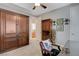 Spacious bedroom with a built-in wardrobe, ceiling fan, and neutral color scheme at 3614 Coventry Gardens Dr, Las Vegas, NV 89135
