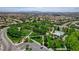 Beautiful community park with manicured lawns, mature trees, walking paths, and clubhouse building at 3614 Coventry Gardens Dr, Las Vegas, NV 89135