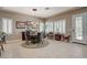 Elegant dining area with a round table, shuttered windows, and a chandelier at 3614 Coventry Gardens Dr, Las Vegas, NV 89135