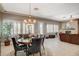 Dining area adjacent to the living room featuring a stone fireplace and natural light at 3614 Coventry Gardens Dr, Las Vegas, NV 89135